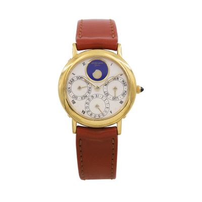 a close up of a gold wrist watch with a white dial