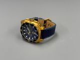 the watch is blue and gold with a leather band
