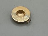 an image of a gold plated metal object on a white surface