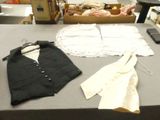 two pieces of clothing on a table next to a pair of scissors