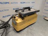 the machine is sitting on the table in front of the wall