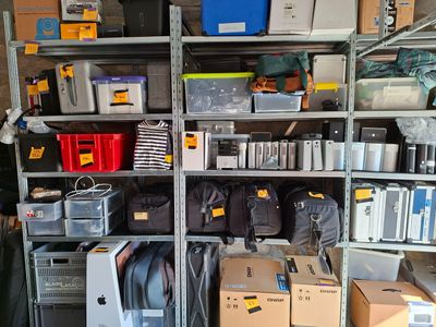 many boxes and boxes on the shelves in the garage