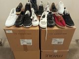 several pairs of shoes sitting on top of boxes in a room