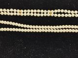 a close up of two pearls on a black surface