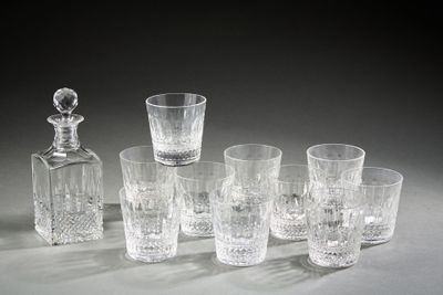 six glasses and a decanter sitting on a table