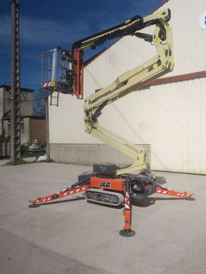 a picture of a man on a cherry picker in front of a building