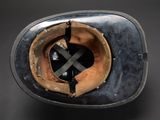 an old baseball helmet with a cross on the side of it