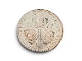 an old silver coin with a crown on it on a white surface