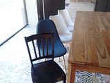 a wooden table with four chairs in the middle of the room