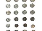 an assortment of old coins on a white surface