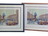 deux tableaux encadrés représentant une rue de la ville avec une tour horloge