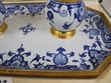 two blue and white vases sitting on a tray
