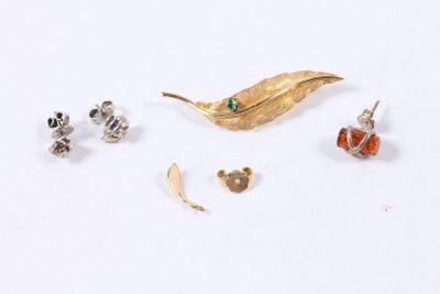 a small collection of jewelry on a white surface