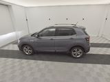 the grey car is parked in the garage on the checkered floor