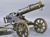 a small metal cannon sitting on top of a wooden cart