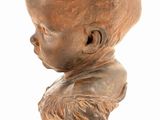 statue of a boy with a beard on a wooden base