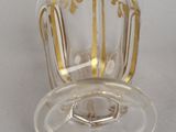 a clear glass cup with a gold decoration on it