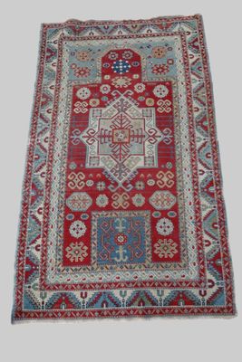a red and blue rug with a pattern on it