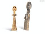two wooden figurines of a man and a woman standing next to each other