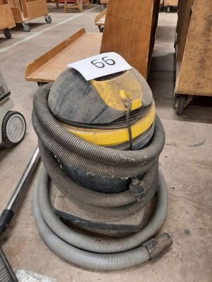 an image of a pile of vacuums in a warehouse