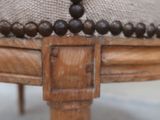 a close up picture of a wooden chair with beads on it