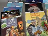 several books are on a table in front of each other