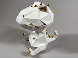 a white origami with gold accents sitting on a table