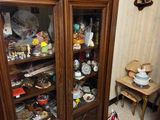 a wooden cabinet with a glass door in a room