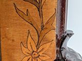 a close up of a wooden frame with flowers on it