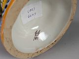 a close up of a vase with a tag on it