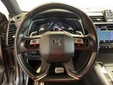 the interior of a car with a steering wheel and dashboard controls