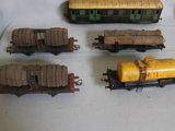 several toy trains are lined up on a white surface