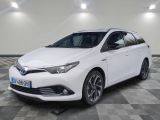 the toyota auris hybrid is parked on a checkered floor