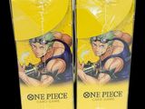 two boxes of one piece card game with a man holding a gun
