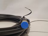 a black wire with a blue button on it