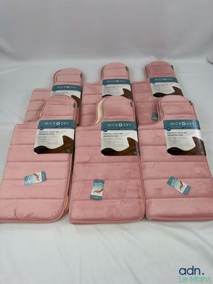 several pink towels are lined up on a white surface