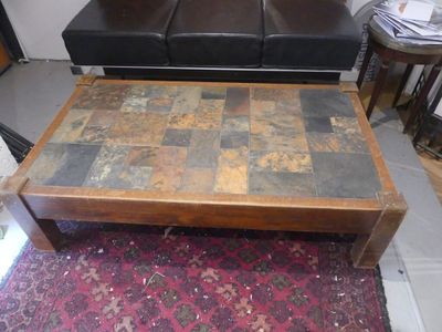 a coffee table that has a tile top on it