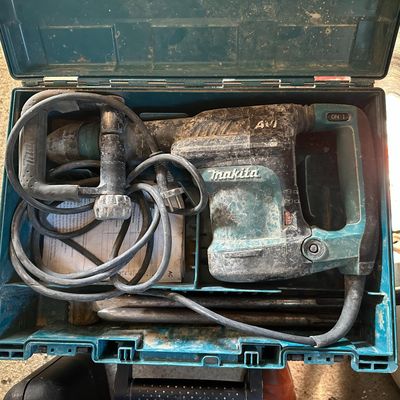 a blue tool box with tools in it on the ground
