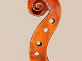 an old violin with a scroll on the back of it