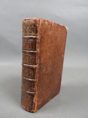 an old book sitting on top of a table next to a gray background