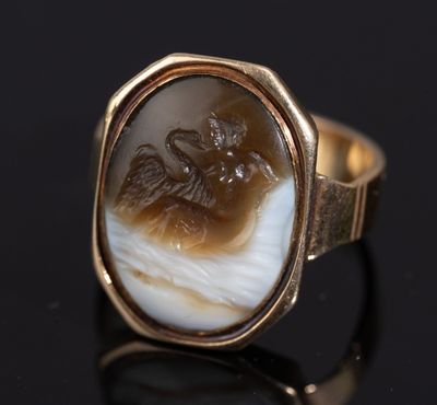 an image of a gold ring with a carved image of a man and a woman