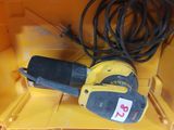 a corded sander in a yellow box with a black cord