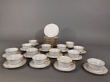 many cups and saucers sitting on the table