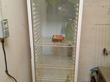 a refrigerator that is sitting in the corner of a room