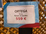 a sign that says ortega on a pole in a store