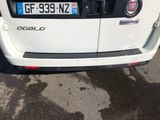a small white car parked on the side of the road