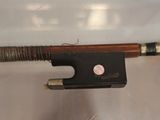 a violin bow that is attached to a piece of wood