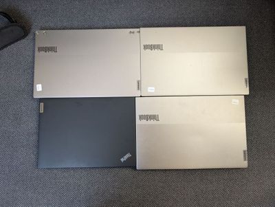 three laptops are sitting on the floor next to each other