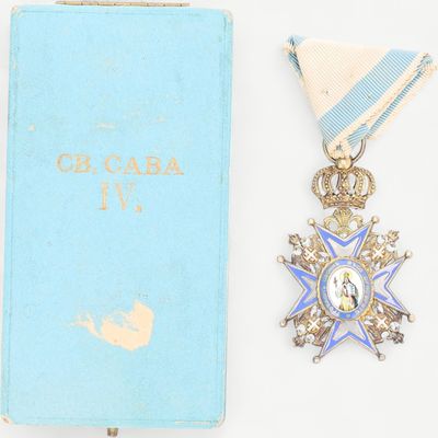 une image représentant un livre bleu avec une médaille d'or et un livre bleu avec un ruban blanc