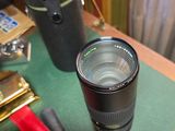a camera lens sitting on top of a desk next to a pair of scissors